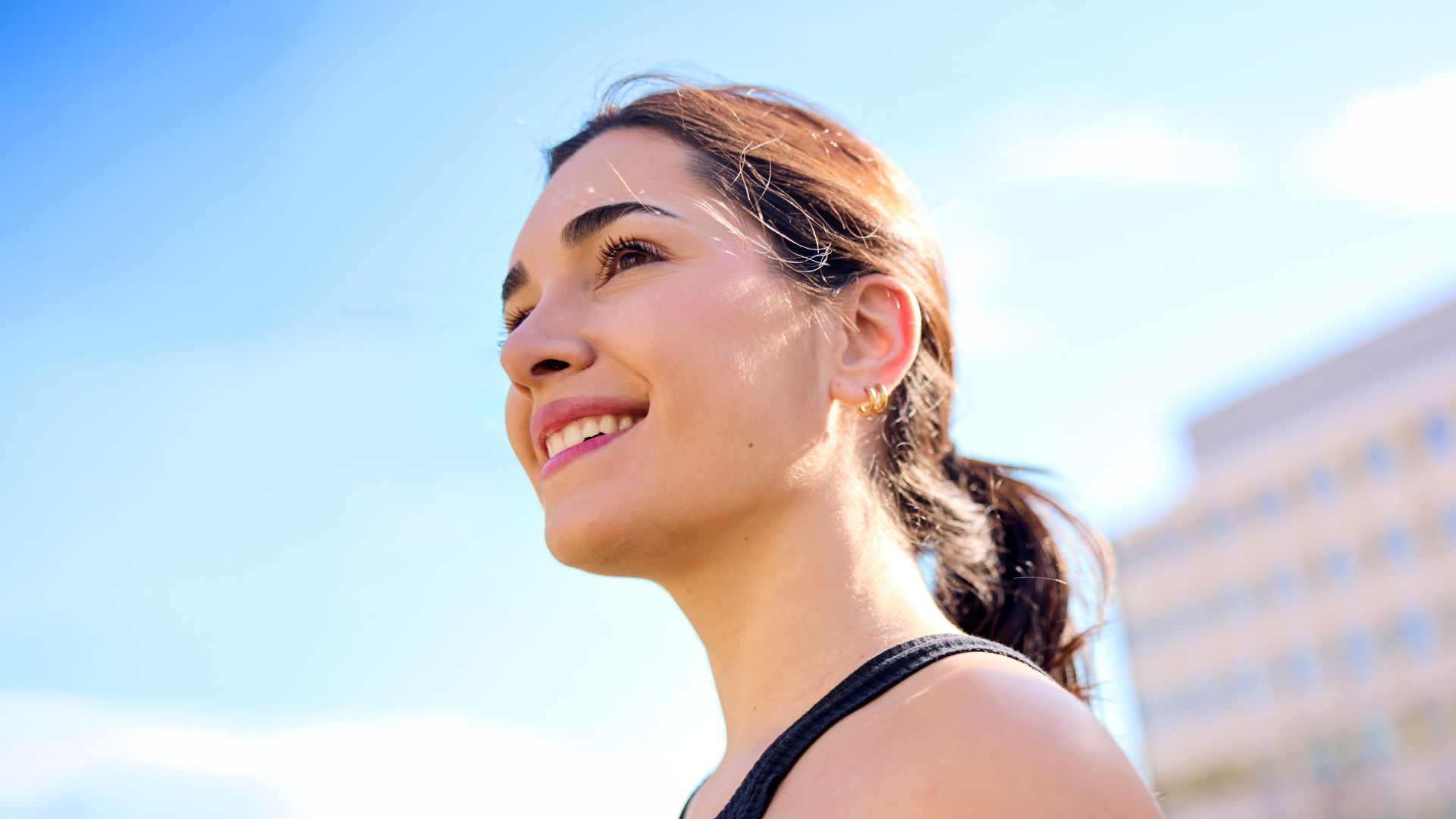 Smiling woman with a blue sky background